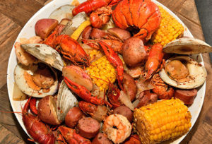 Low Country Boil on a plate with crawfish, corn, shrimp, sausage